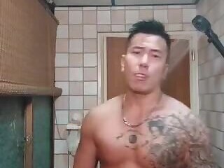 Tattoo muscle is having fun in the toilet