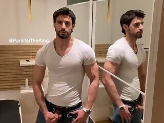 A muscular guy standing and masturbating, then licking his own cum.