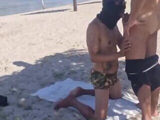 masked man having sex on the beach