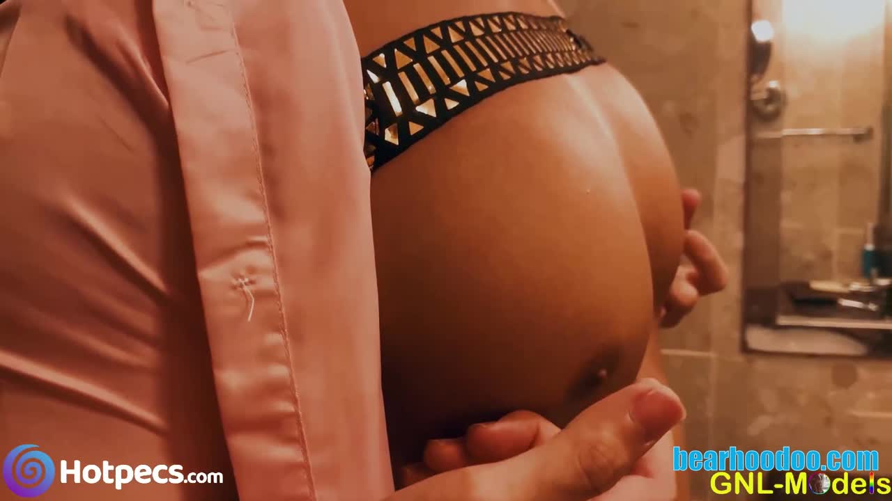 A muscular man is playfully teasing another mans nipples